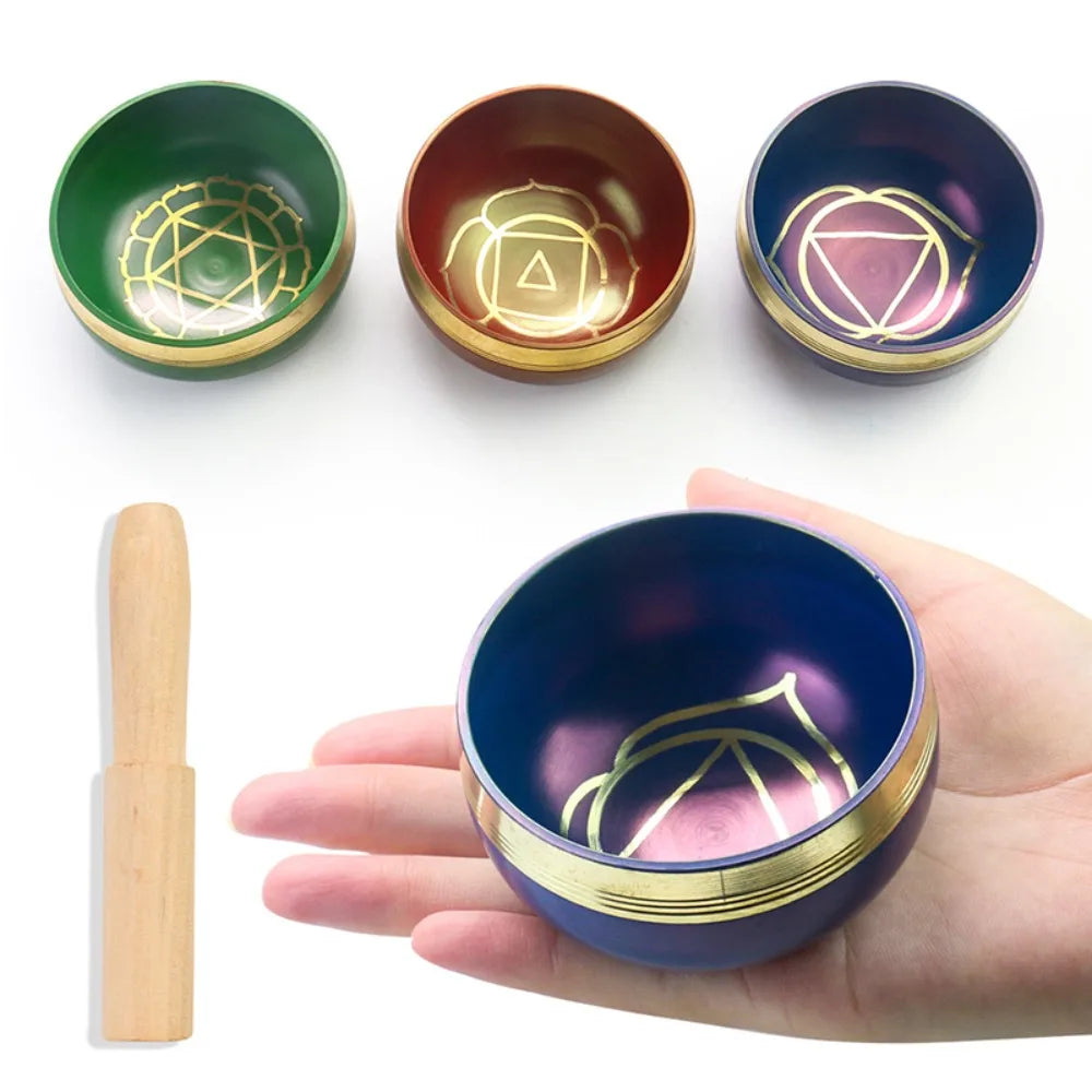 Set of three decorative bowls with geometric designs, one held in a hand for size reference.